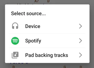 A popup with the text 'Select source... Device, Spotify, Pad backing tracks'